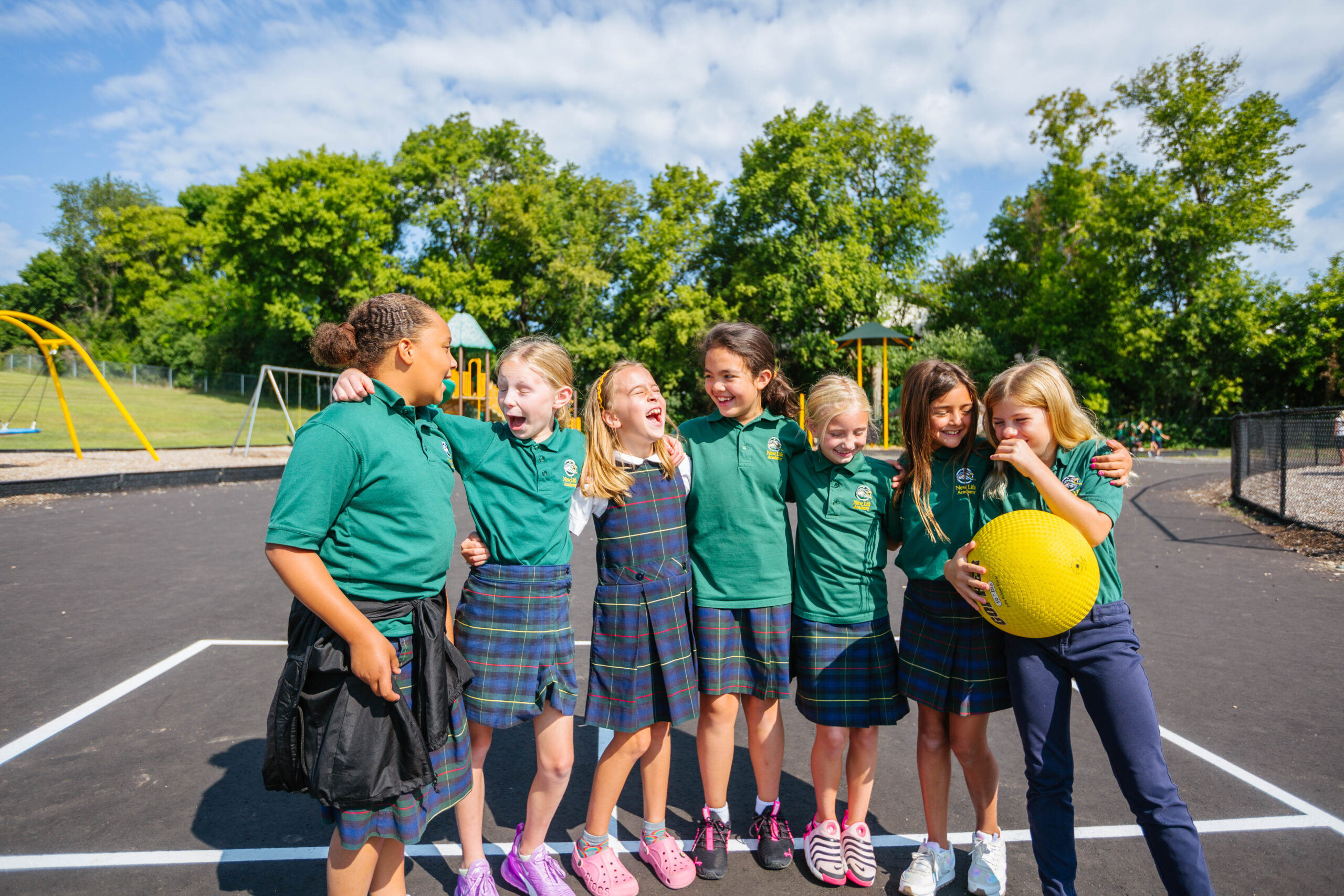 A group of happy girls enjoy a playful moment on the playground.